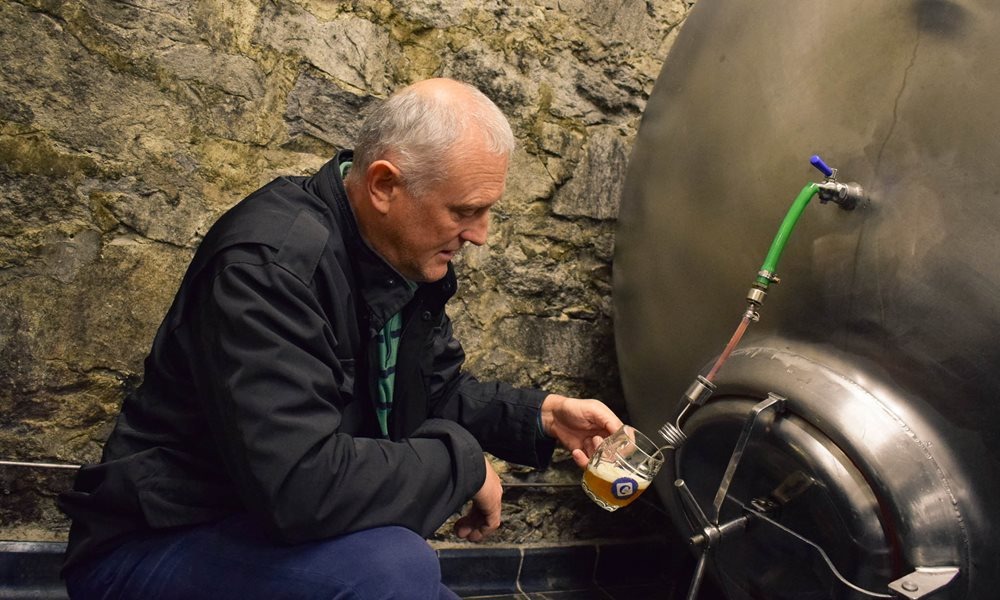A Man Filling Glass of Beer from Beer Keg